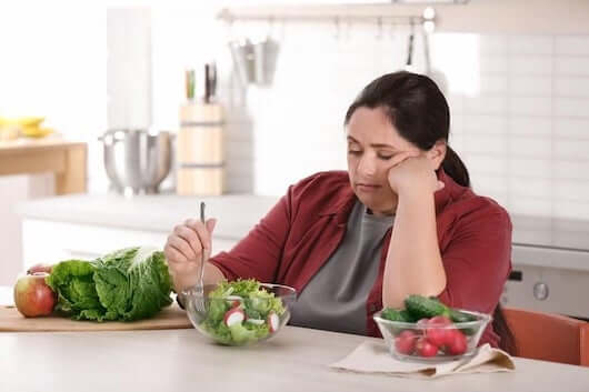 Unhappy_Woman_Eating_Salad